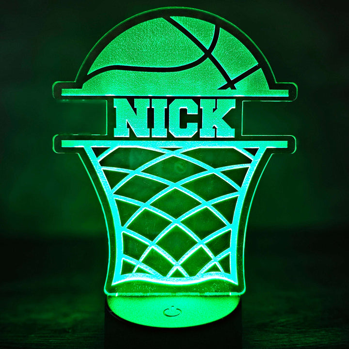 Green basketball hoop night light with 'NICK' text on a dark background
