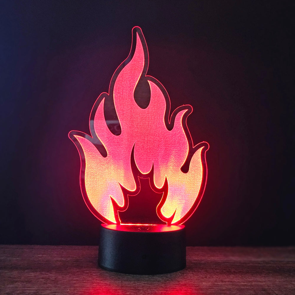 Flame-shaped LED night light on a dark background
