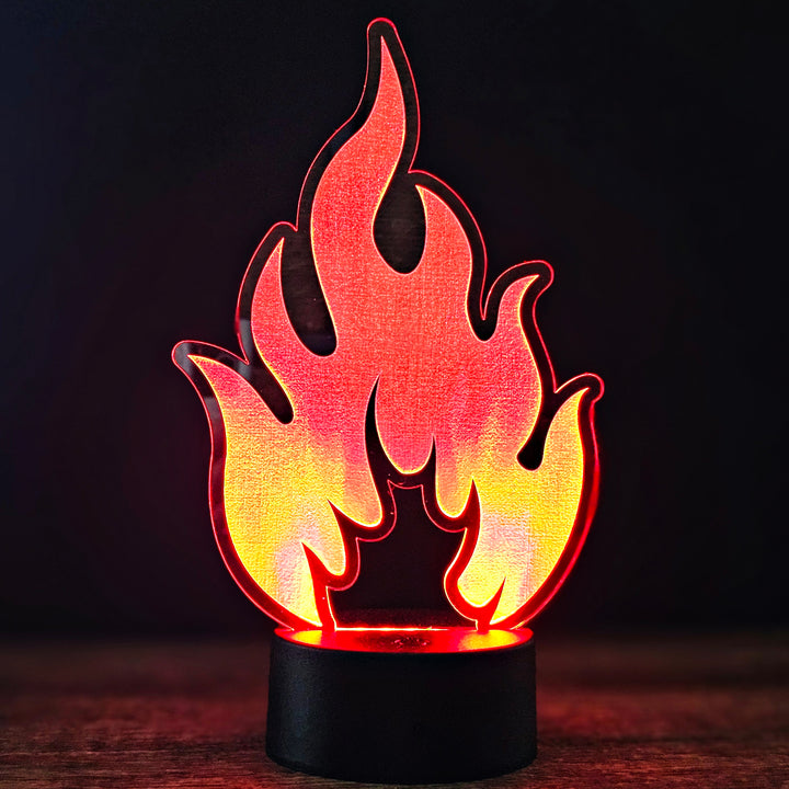 Flame-shaped LED night light on a dark background