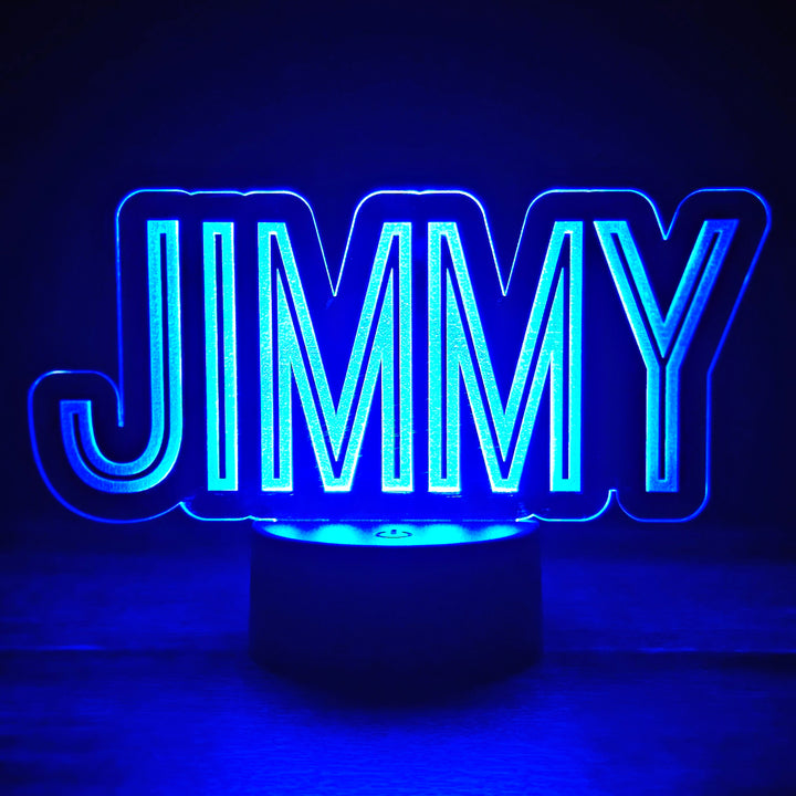 LED night light with the name 'JIMMY' engraved on acrylic lit in blue in a black background