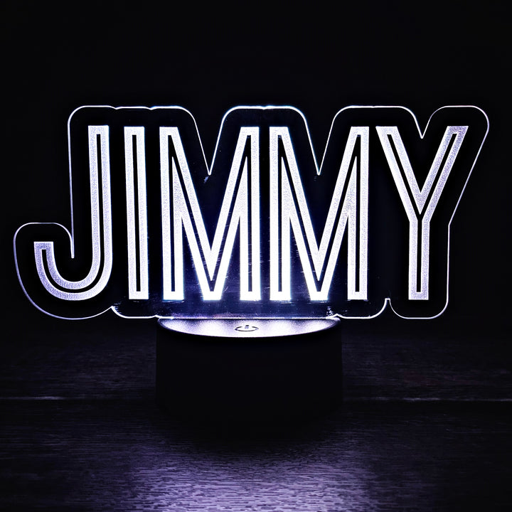 LED night light with the name 'JIMMY' engraved on acrylic lit in a black background