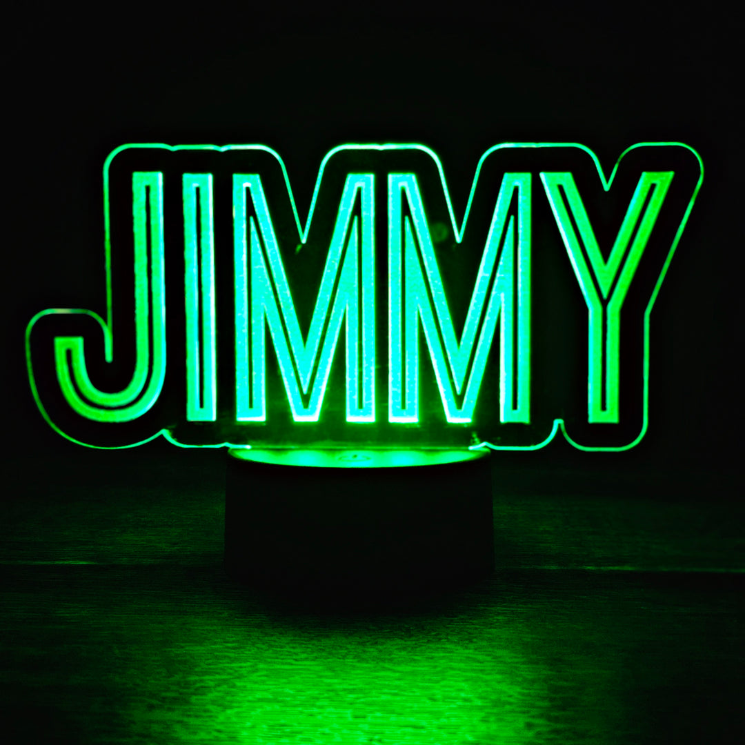 LED night light with the name 'JIMMY' engraved on acrylic lit in green in a black background