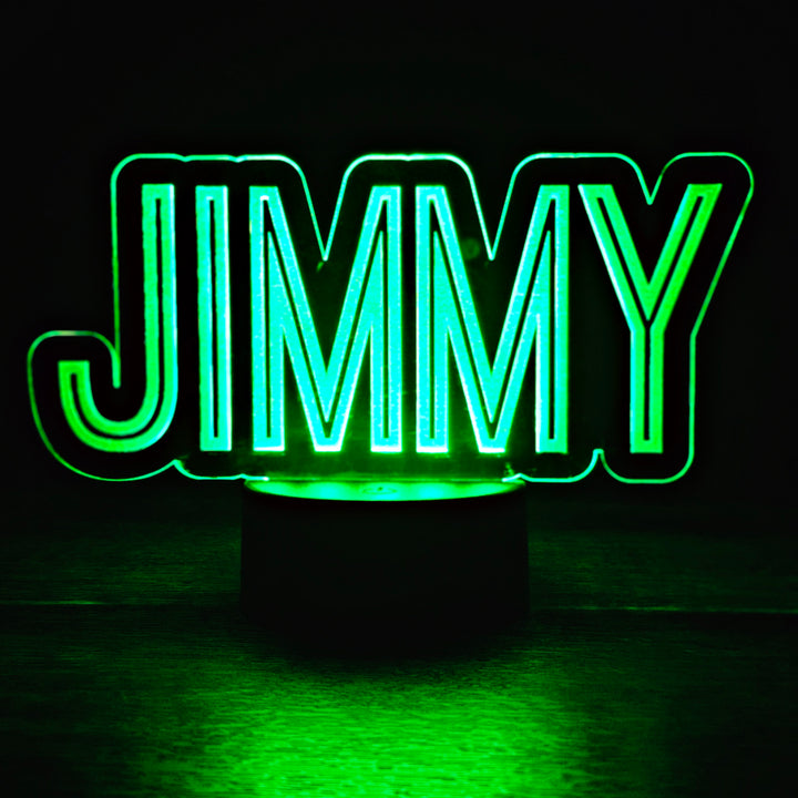 LED night light with the name 'JIMMY' engraved on acrylic lit in green in a black background