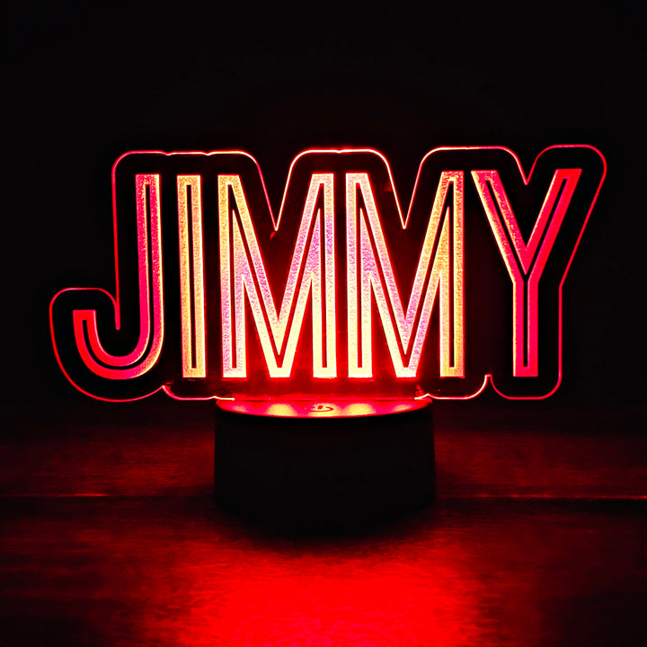 LED night light with the name 'JIMMY' engraved on acrylic lit in red in a black background