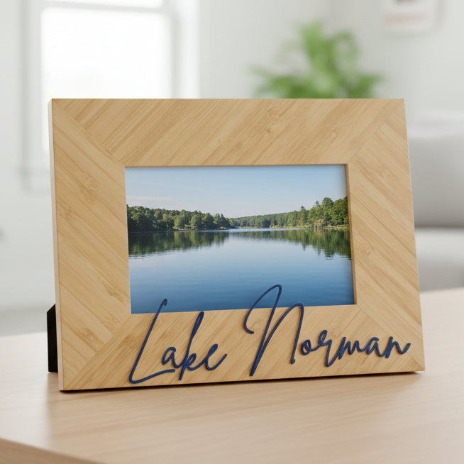 A rectangular bamboo picture frame with a herringbone pattern, featuring the name &