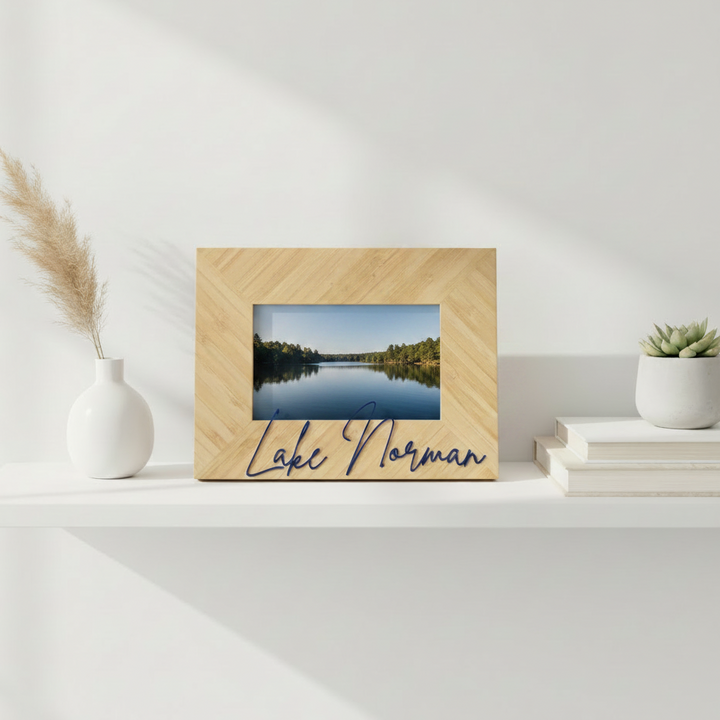 A personalized wooden bamboo picture frame with a herringbone pattern, featuring a landscape photo of a lake and the text &