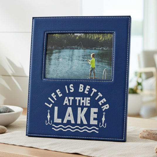 A blue faux-leather picture frame with white stitching and the phrase &