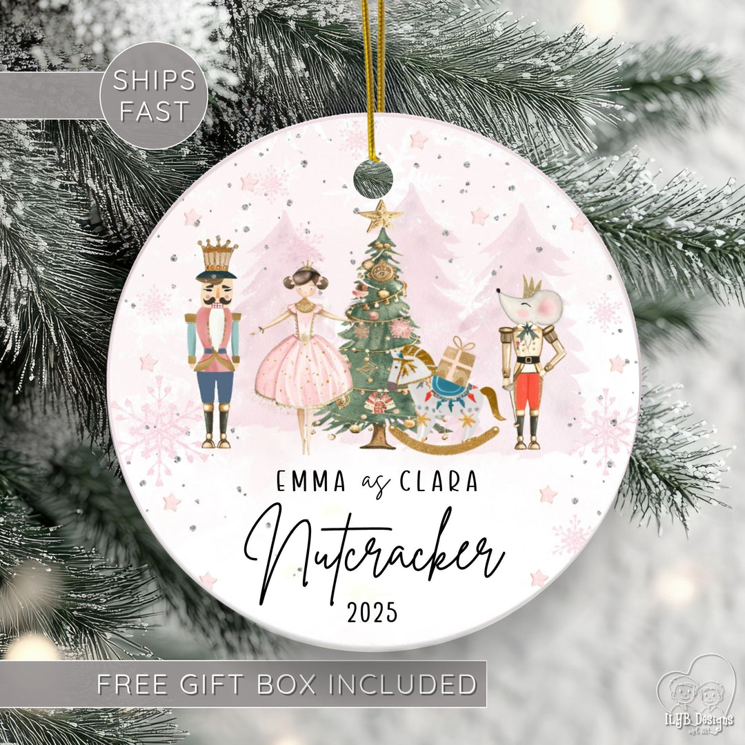 Personalized Nutcracker ballet ornament featuring a beautiful watercolor Nutcracker scene with classic characters on a round ceramic Christmas ornament. 3 rows of black text. First line personalized with "Anne Marie Dance Studio", 2nd line "Nutcracker" in elegant script font, 3rd line has the current year. Ships fast & free gift box included.