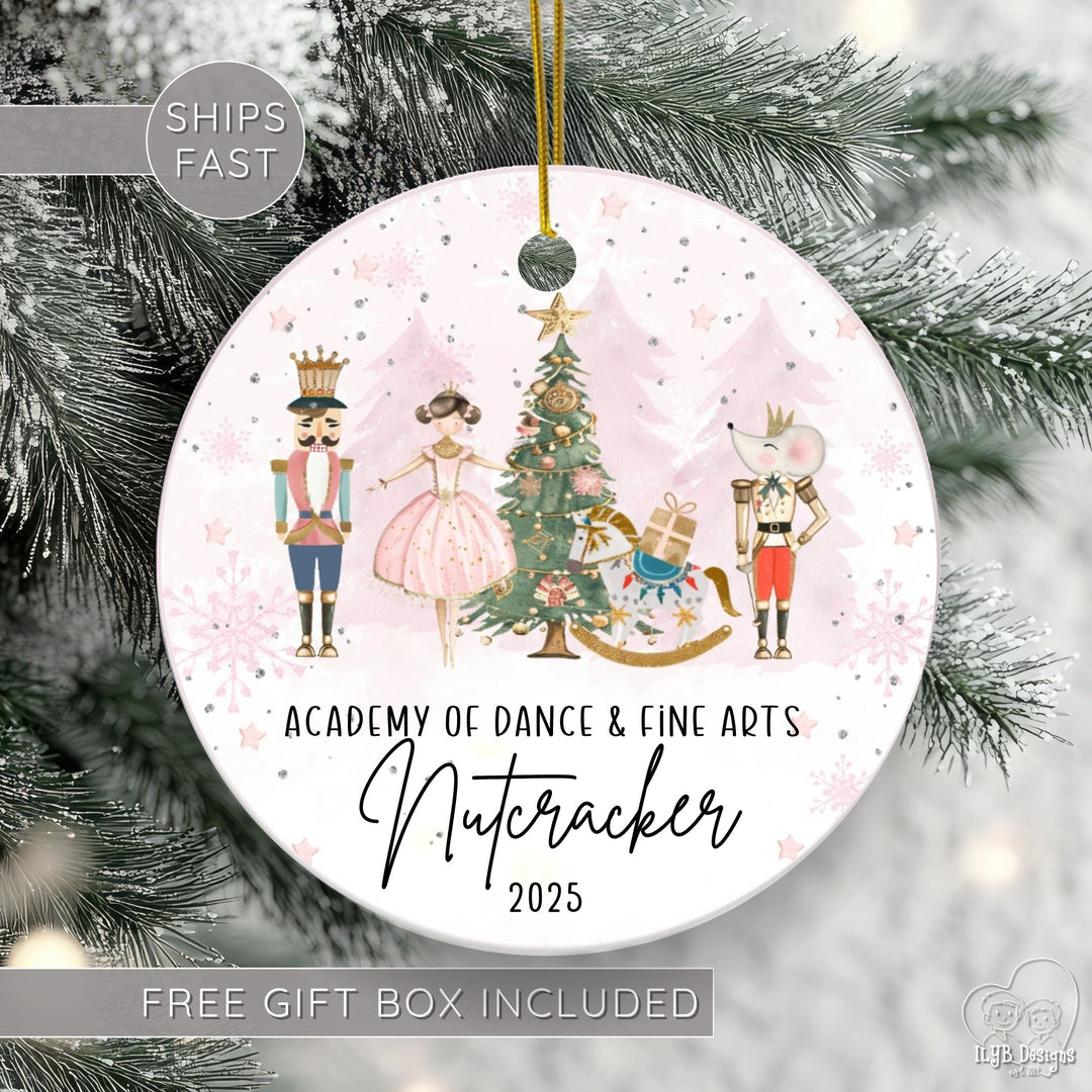 Personalized Nutcracker ballet ornament featuring a beautiful watercolor Nutcracker scene with classic characters on a round ceramic Christmas ornament. 3 rows of black text. First line personalized with "Anne Marie Dance Studio", 2nd line "Nutcracker" in elegant script font, 3rd line has the current year. Ships fast & free gift box included.