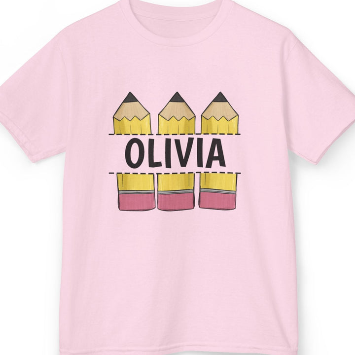 A light pink short-sleeve t-shirt with a graphic on the front showing three yellow pencils with the name 'OLIVIA' in black, and three matching pencils below, displayed on a clean white background.