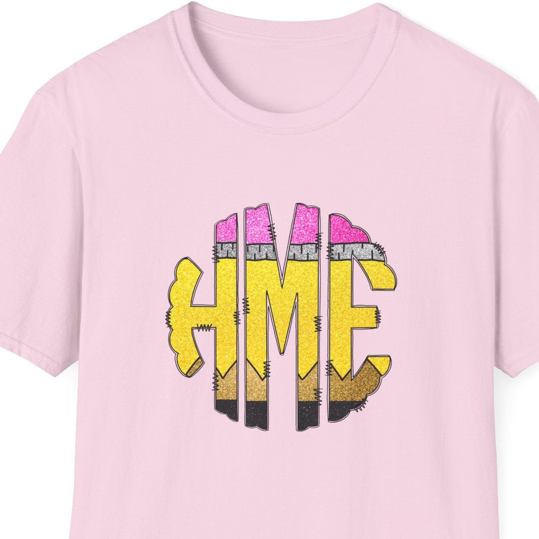 A light pink short-sleeve crewneck t-shirt featuring a graphic on the chest with the letters 'HME' in yellow, stylized as pencils.