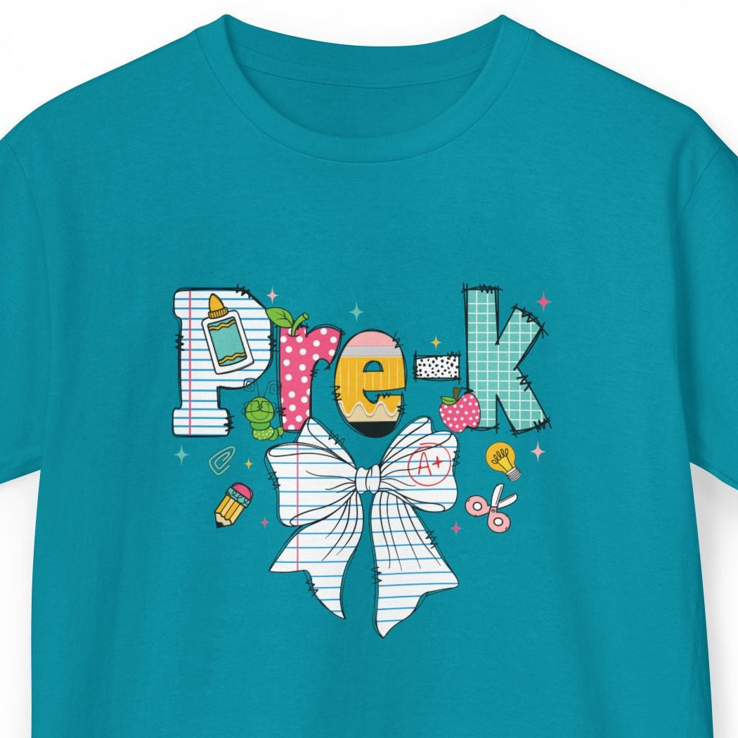 A teal short-sleeve t-shirt with a colorful 'Pre-k' graphic on the chest, featuring a white bow illustration and small school-themed doodles, shown against a plain white background.