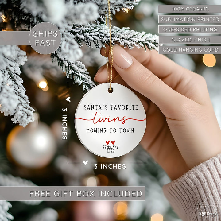 Hand hanging "Santa's favorite twins coming to town" ornament on a Christmas tree and showing dimensions of the ornament in perspective next to the hand. Ornament dimensions are 3 inches x 3 inches. Other features are highlighted: 100% ceramic, sublimation printing, one-sided print, glazed finish, gold hanging cord, free gift box included, ships fast.