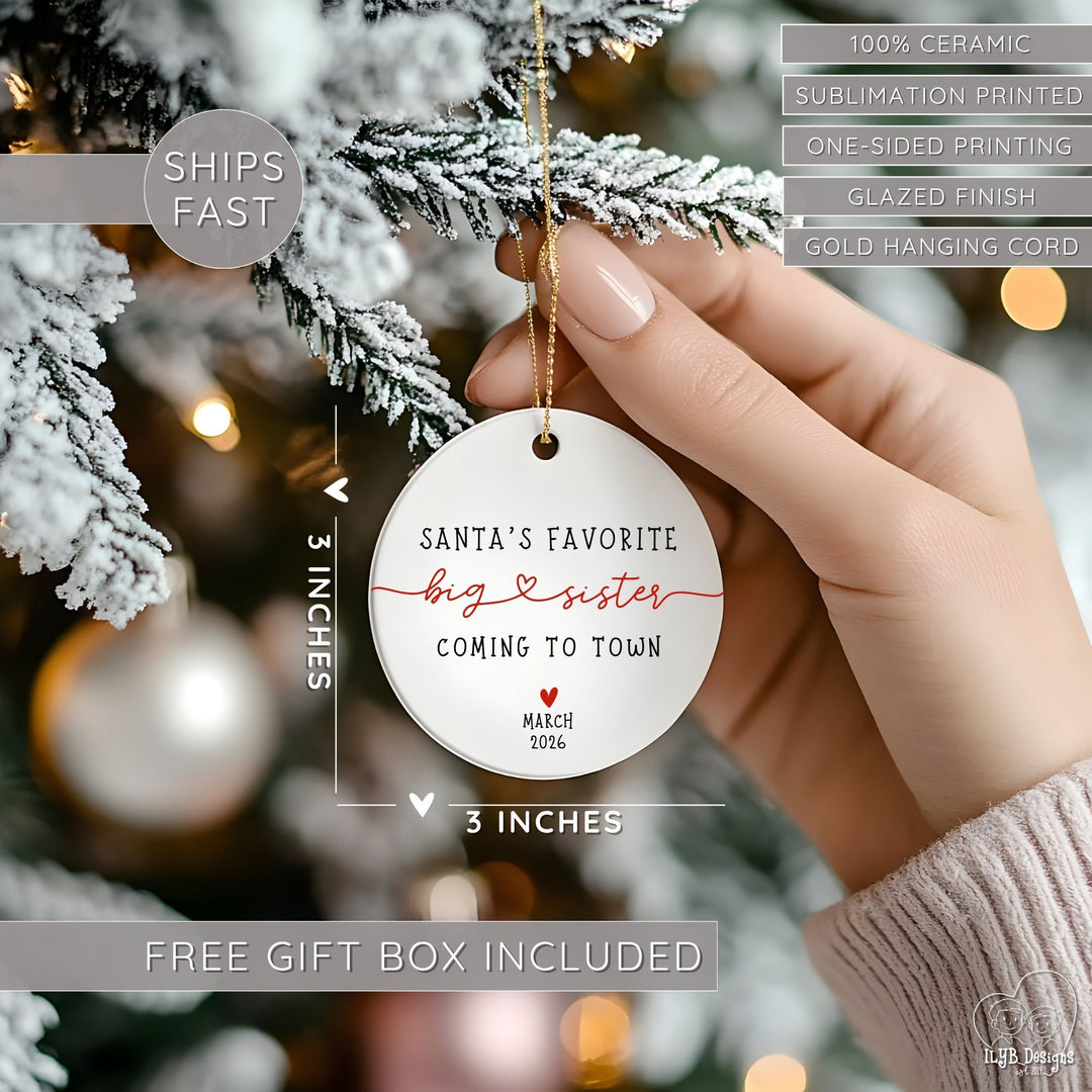 Hand hanging "Santa's favorite big sister coming to town" ornament on a Christmas tree and showing dimensions of the ornament in perspective next to the hand. Ornament dimensions are 3 inches x 3 inches. Other features are highlighted: 100% ceramic, sublimation printing, one-sided print, glazed finish, gold hanging cord, free gift box included, ships fast.