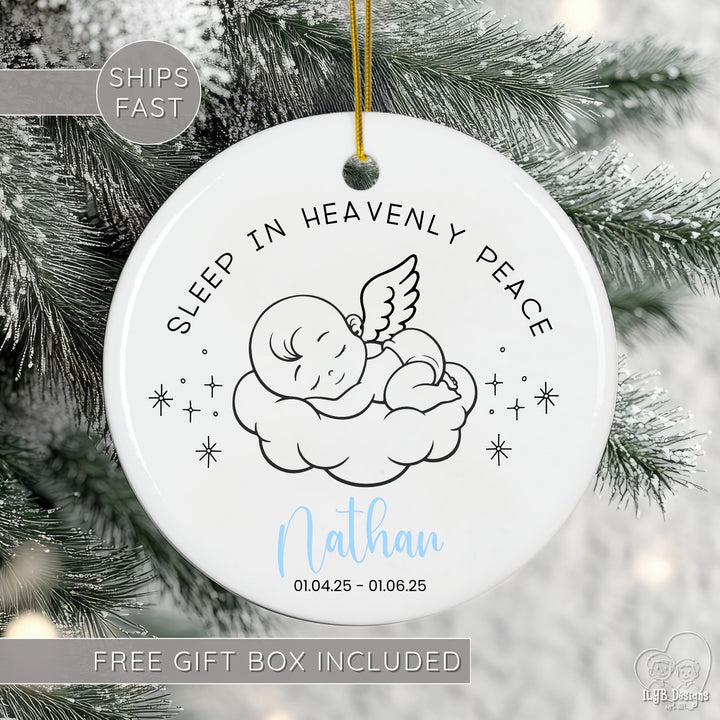 Personalized baby memorial ornament featuring the tender phrase “Sleep in Heavenly Peace.” A sweet line drawing of an angel baby resting on a cloud surrounded by stars creates a touching keepsake. Under the angel baby is the name "Nathan" in a light blue script font with the year in black under the name.