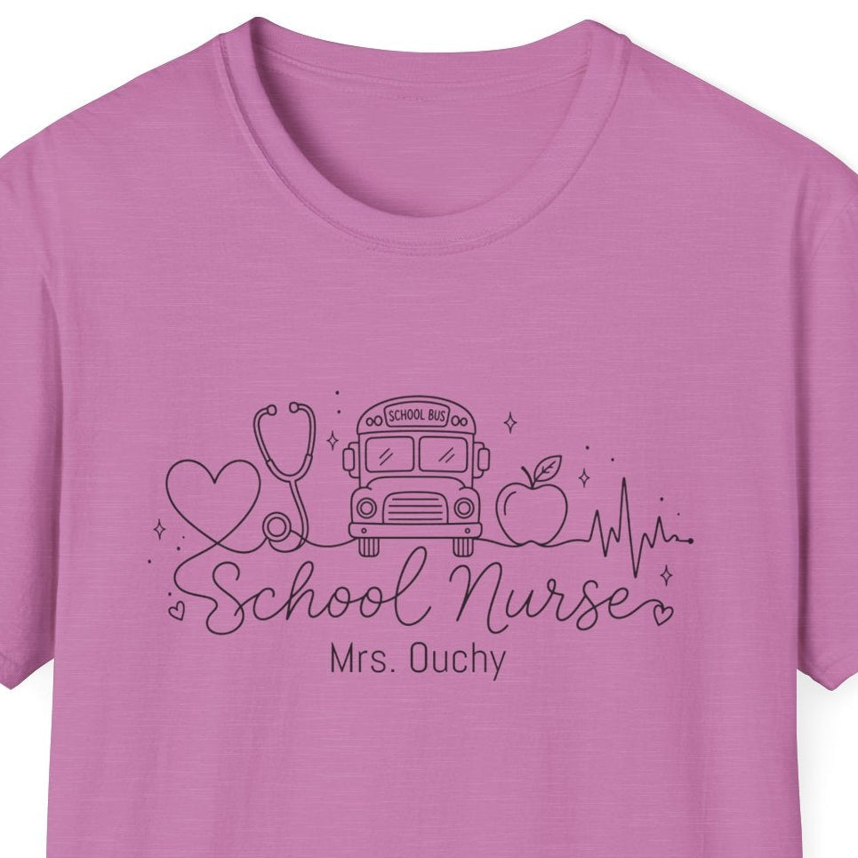A pink short-sleeve crewneck t-shirt with a dark purple graphic on the chest featuring school nurse line drawn icons and the text 'School Nurse Mrs. Ouchy', displayed on a solid white background.