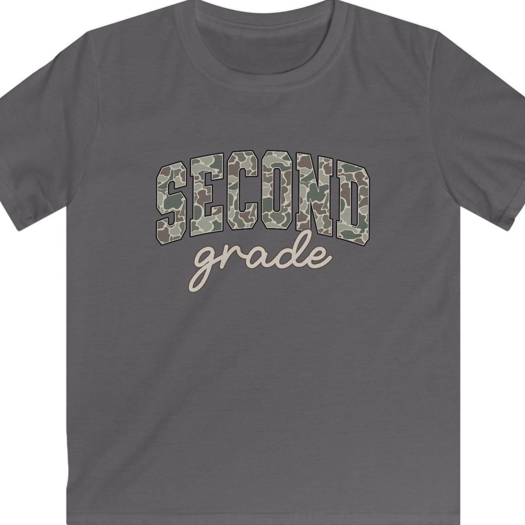A charcoal gray short-sleeve t-shirt with 'SECOND grade' printed on the chest. The word 'SECOND' is in arched block letters filled with a tan and brown camouflage pattern, while 'grade' is written below in a light beige cursive script.