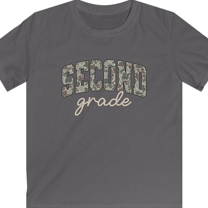 A charcoal gray short-sleeve t-shirt with 'SECOND grade' printed on the chest. The word 'SECOND' is in arched block letters filled with a tan and brown camouflage pattern, while 'grade' is written below in a light beige cursive script.