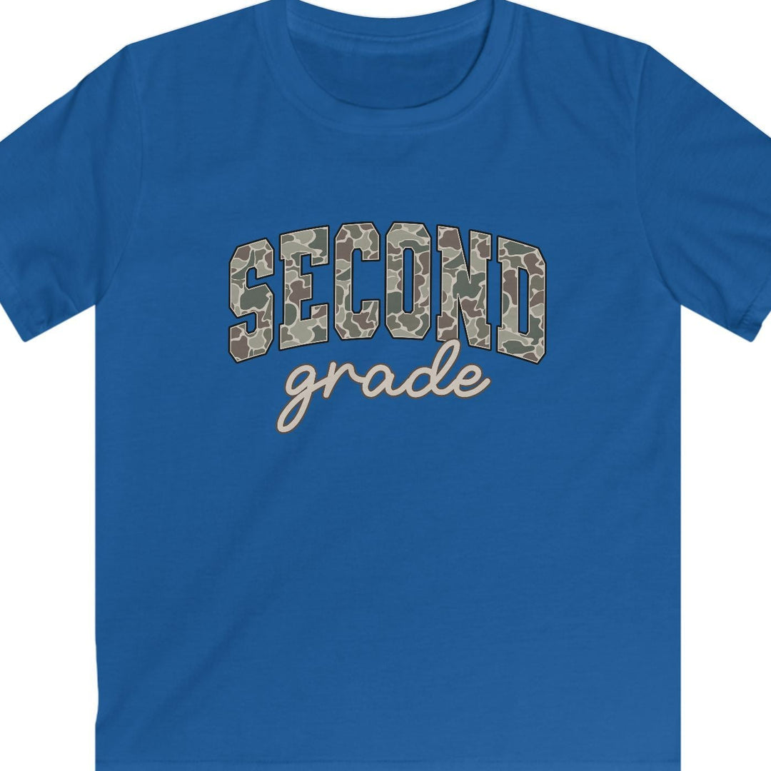 A royal blue short-sleeve t-shirt with 'SECOND grade' printed on the chest. The word 'SECOND' is in arched block letters filled with a tan and brown camouflage pattern, while 'grade' is written below in a light beige cursive script.