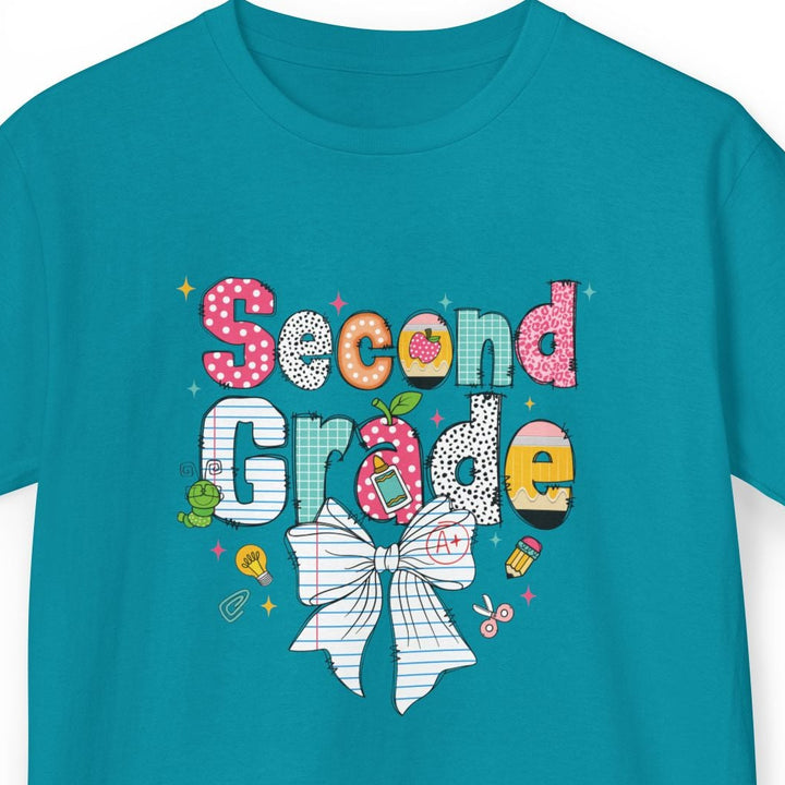 A teal short-sleeve kids' t-shirt with a colorful 'Second Grade' graphic on the chest, featuring a white bow illustration and small decorative icons, shown on a plain white background.