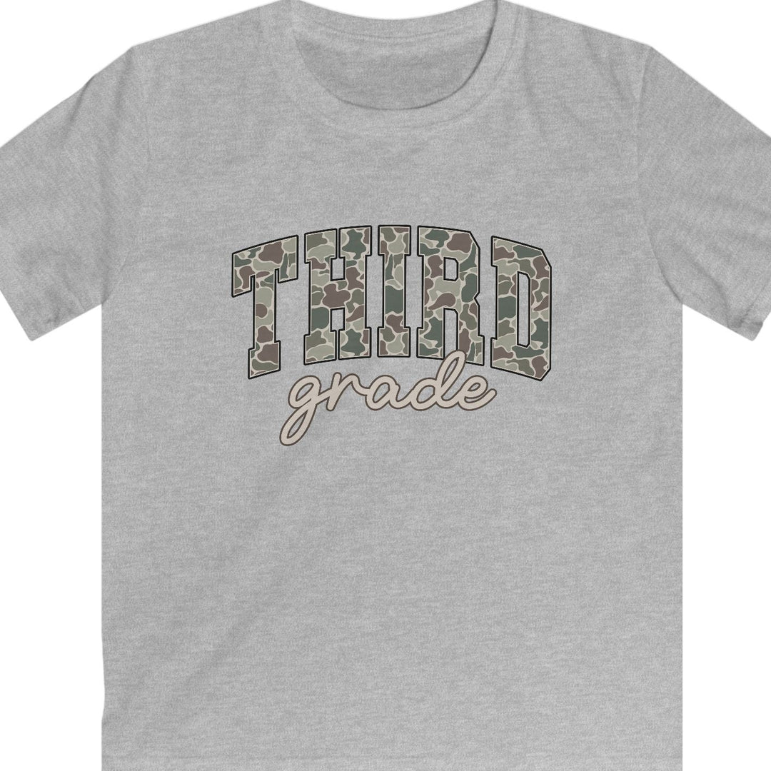 A heather gray short-sleeve t-shirt with a graphic on the chest reading 'THIRD grade' in camouflage block letters and beige cursive script, shown on a plain white background.