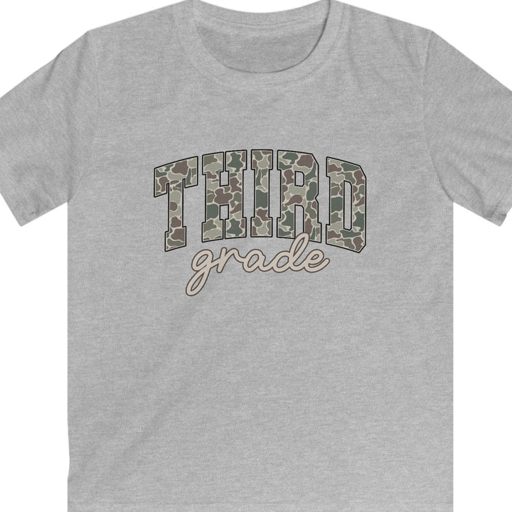 A heather gray short-sleeve t-shirt with a graphic on the chest reading 'THIRD grade' in camouflage block letters and beige cursive script, shown on a plain white background.