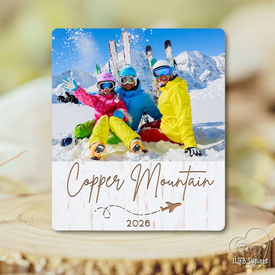 Personalized photo plaque with skiers at Copper Mountain 2026 on a wooden surface.