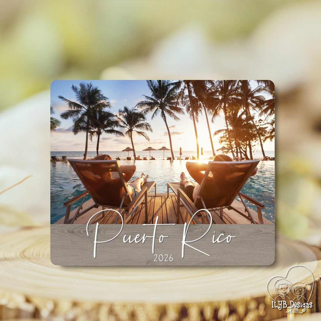 Photo board plaque with a tropical scene of two chairs by the water and palm trees, with 'Puerto Rico 2026' text.
