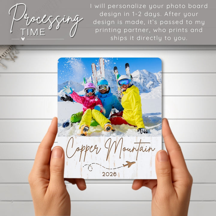 Personalized photo board with skiers at Copper Mountain 2020 held by hands on a wooden surface.