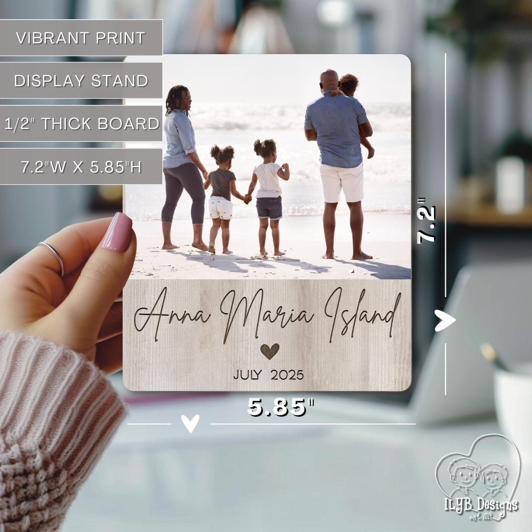 Wooden photo block with family photo and 'Anna Maria Island' text, held by a hand.
