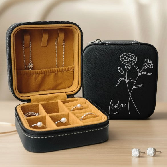 Black jewelry case with floral design and script name engraved in metallic silver and jewelry inside 