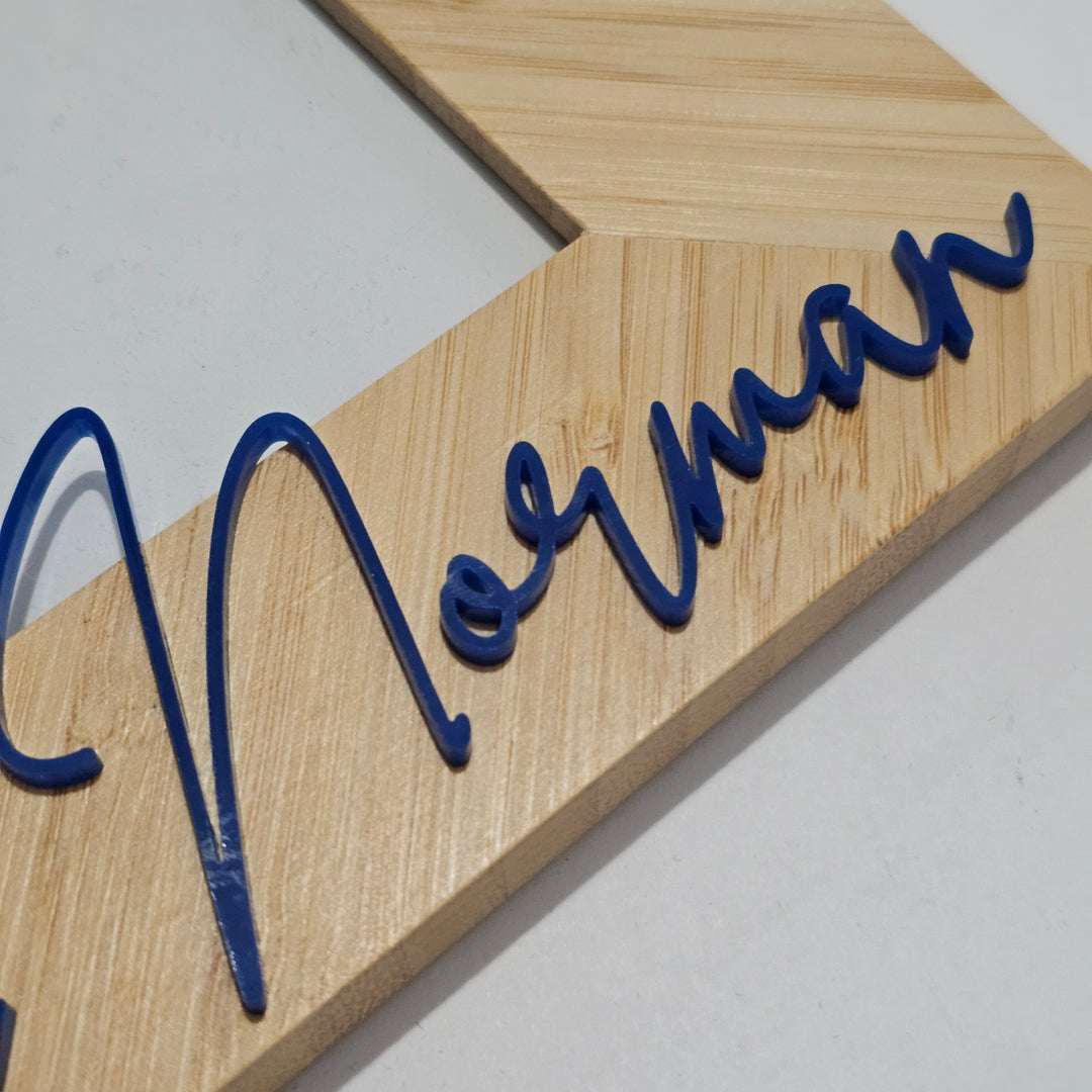 Close-up of a wooden decorative letter sign with the name &