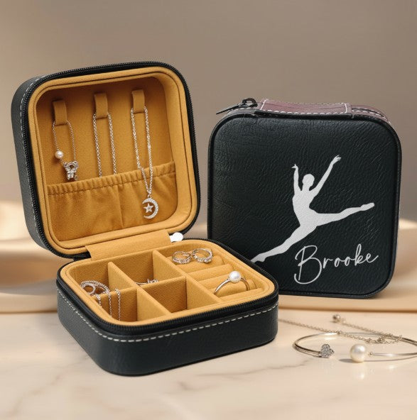 Black leatherette travel jewelry box with dancer silhouette and engraved name, closed view showing zipper closure
