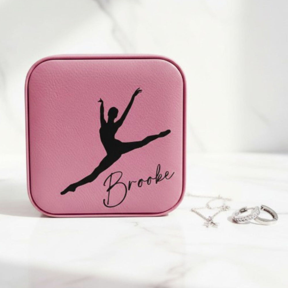 Pink jewelry case with a black silhouette of a dancer and the name 'Brooke' engraved in black on it