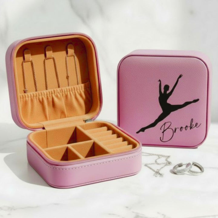 Pink leatherette travel jewelry box with dancer silhouette and engraved name, closed view showing zipper closure