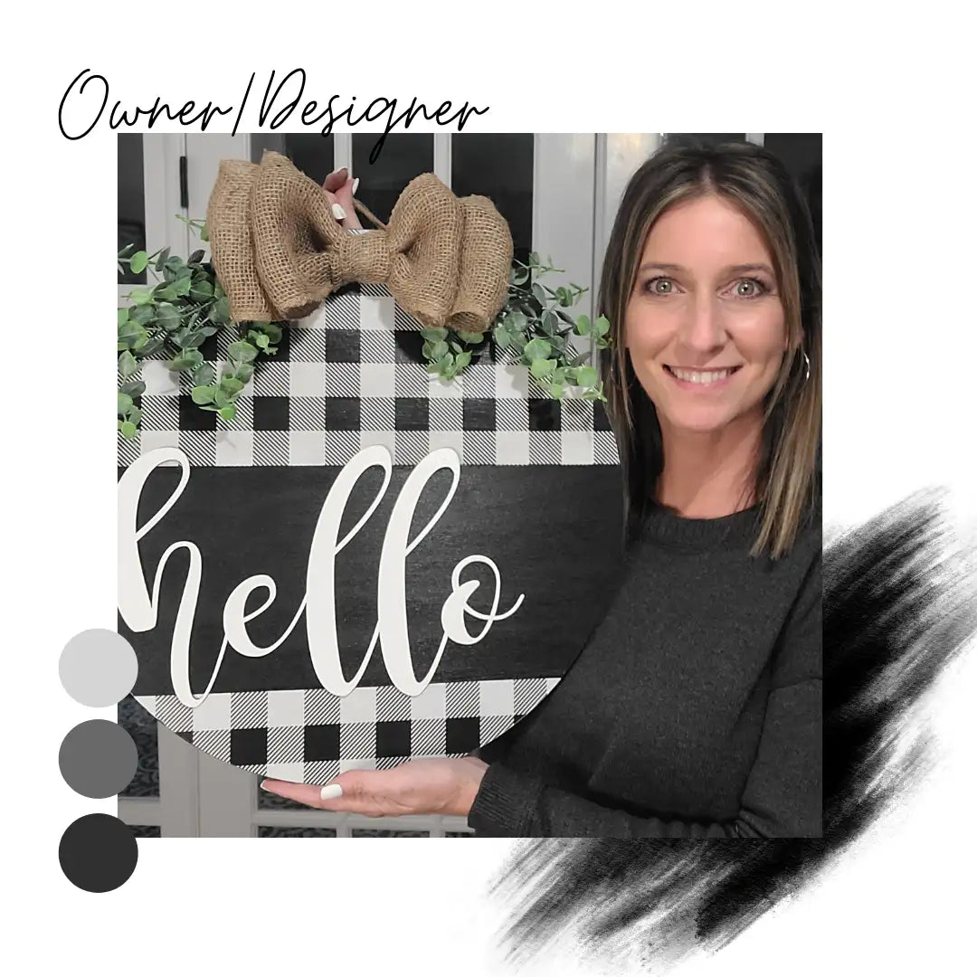 Stephanie Miller holding a round door hanger with "hello" in script font. Black and white buffalo plaid is on the top and bottom of the sign. A burlap bow and greenery completes the top of this door hanger.