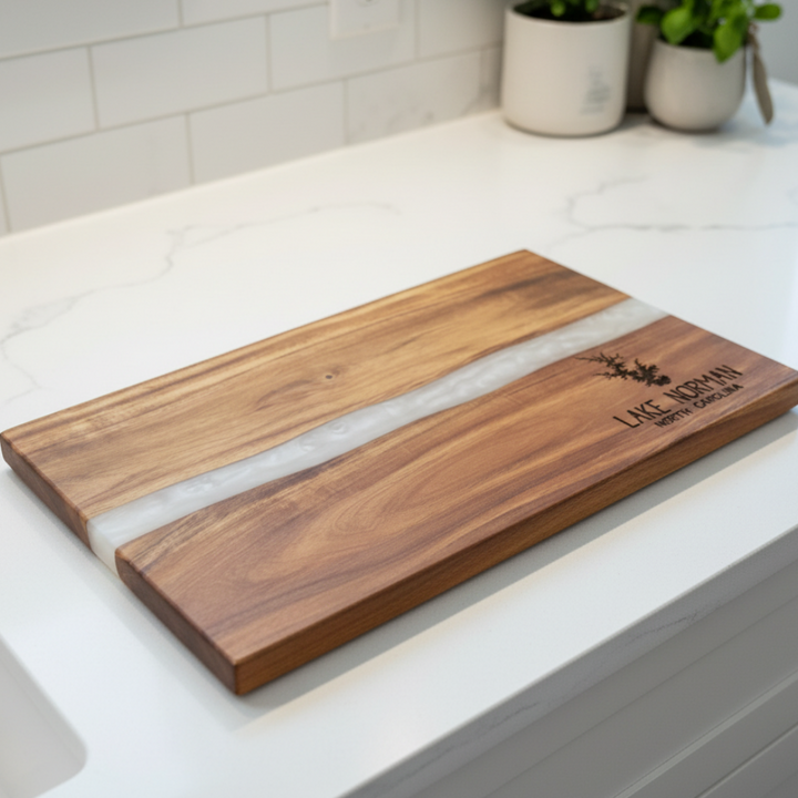 Wooden cutting board with white resin inlay on a kitchen counter