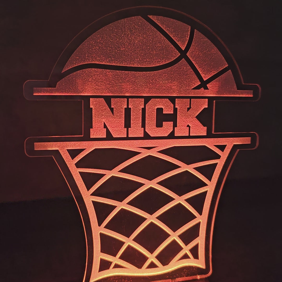 video of LED basketball night light with the name Nick in between a basketball and basketball net, glowing in dark