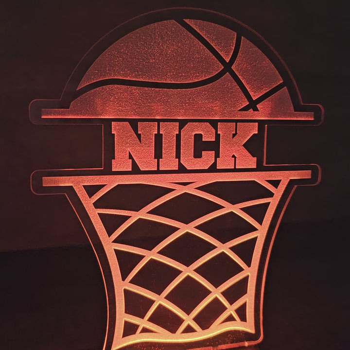 video of LED basketball night light with the name Nick in between a basketball and basketball net, glowing in dark