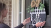 video: hands making a handmade round door sign