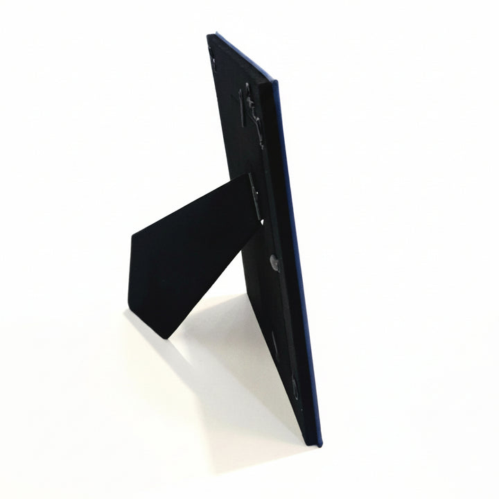 A black picture frame stand photographed from the side.