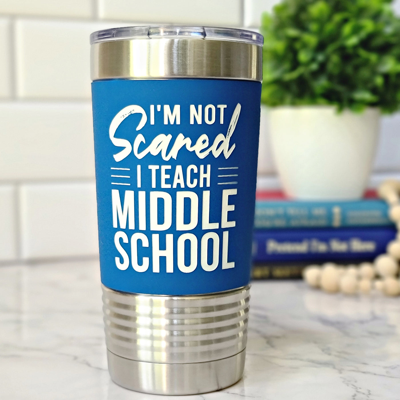 Blue Polar Camel stainless steel tumbler with silicone sleeve laser engraved in white and says I'm not scared I teach middle school.