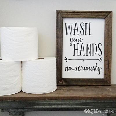 Dark walnut stained 9"x12" frame on a white canvas with black words that read, "Wash your hands, no...seriously." Design is placed vertically on sign.