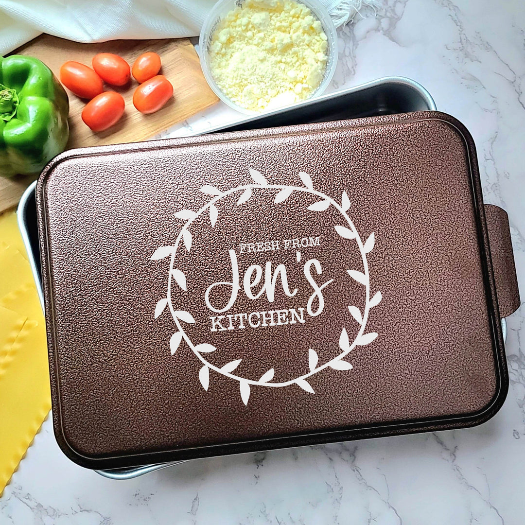 Aluminum cake baking pan with copper lid with laser engraving 'Fresh from Jen's Kitchen' text in a decorative wreath.