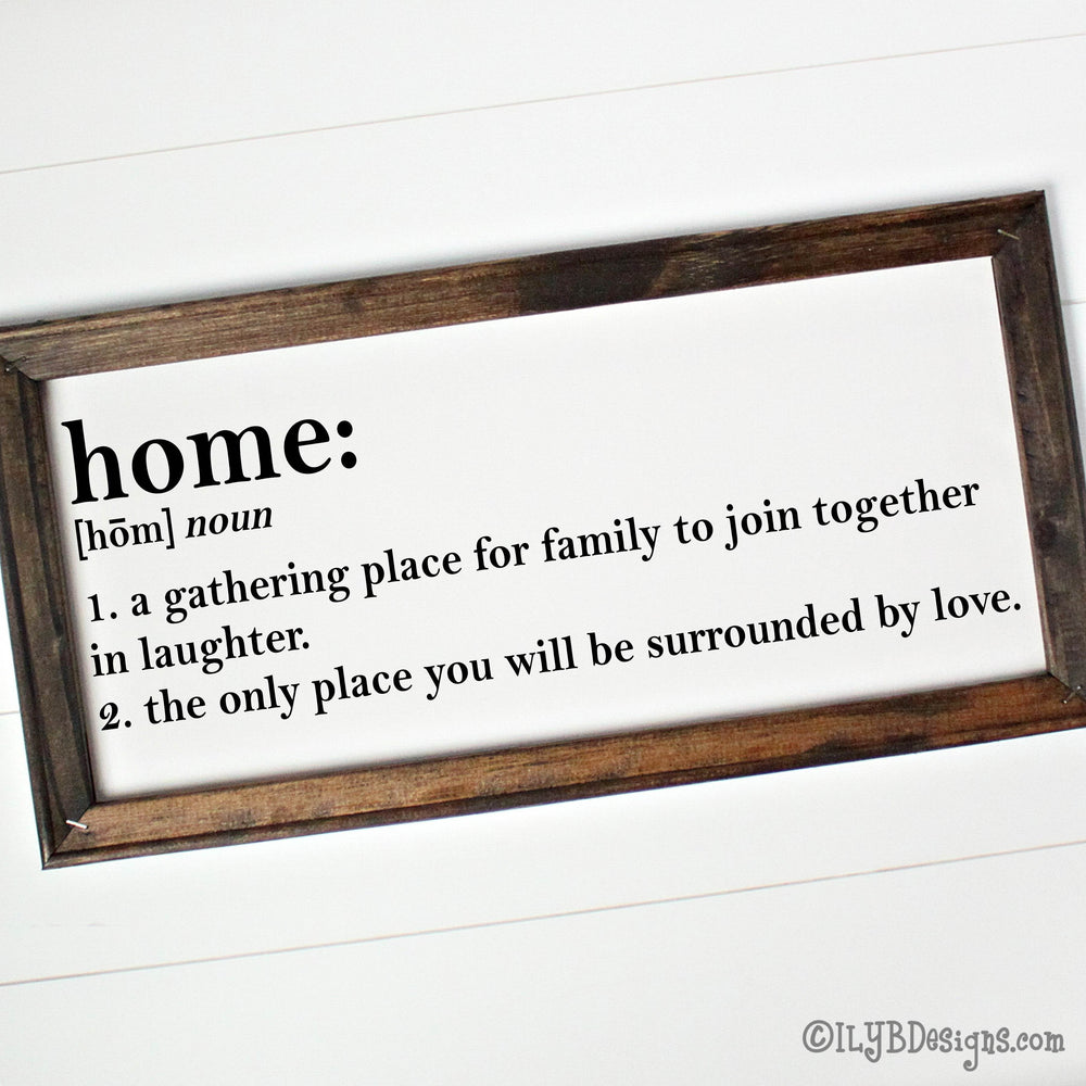 Wooden-framed canvas sign with definition of 'home: A gathering place for family to join together in laughter. The only place you will be surrounded by love.' in black text.