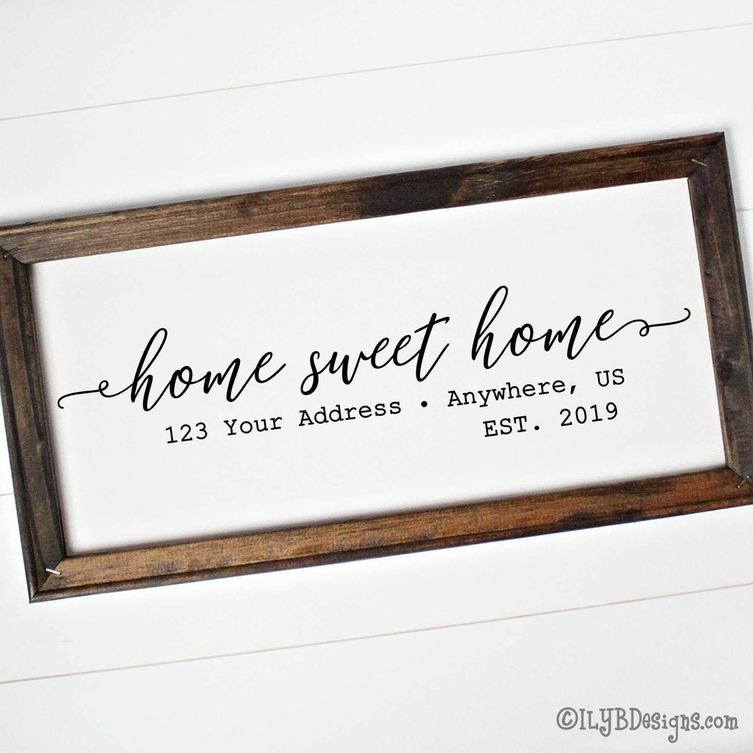 Personalized 'home sweet home' sign with wooden frame on a white canvas. A custom address and established date is underneath the phrase.