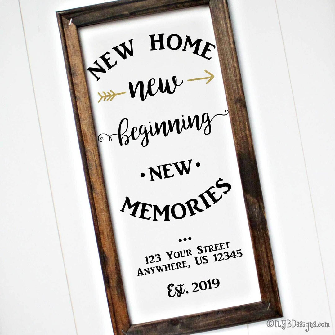 Decorative sign with 'New Home New Beginning New Memories' black text on a white canvas with brown wood frame.