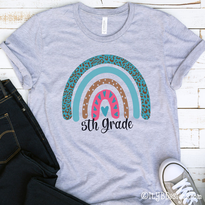 Youth athletic heather gray back to school shirt with pink and teal leopard print rainbow with a custom grade below it in a black script font.
