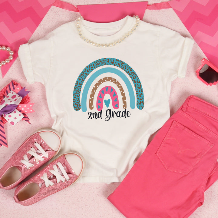 White toddler shirt with pink and teal leopard print rainbow. Under rainbow in black script is custom grade level.