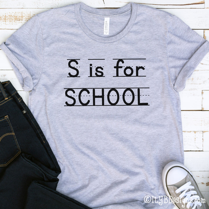 Athletic heather gray S is for School back to school shirt with a playful print font, complete with elementary lined writing lines. Design is in black.